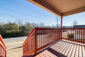 a porch with a wooden railing on a house at Chill on the Hill in Fayetteville