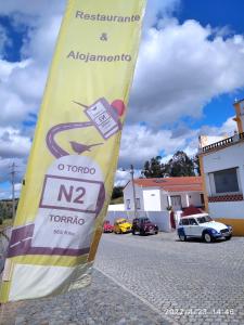 a flag on the side of a street at Alojamento O Tordo in Torrão