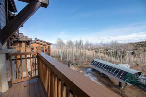 a view from the balcony of a log cabin with aperature at Silver Strike Condo by Lespri Property Management in Park City