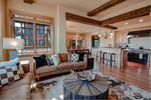a living room with a couch and a table at Silver Strike Condo by Lespri Property Management in Park City