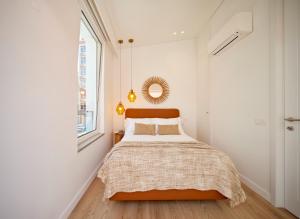 a bedroom with a bed and a mirror on the wall at Bougainvillea 33 by My Cozy Home in Faro