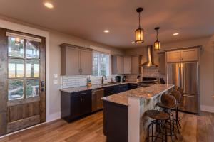 a kitchen with a large island with bar stools at The Grape Escape at Eagles Nest in Elk Park