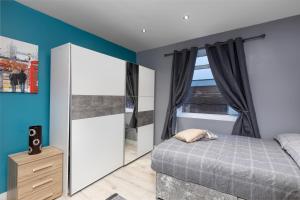 a bedroom with a bed and a large mirror at Central Roof Terrace Apartment in Stockton-on-Tees