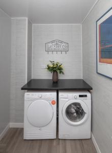 a laundry room with a washing machine and a counter at Central Roof Terrace Apartment in Stockton-on-Tees