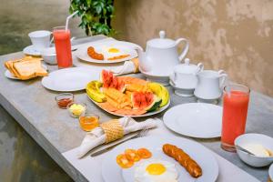 a table topped with plates of food and eggs at Urchin Unawatuna in Unawatuna