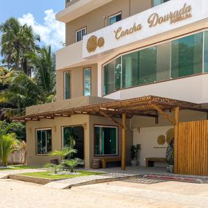 a building with a sign for a restaurant at Pousada Concha Dourada in Maragogi