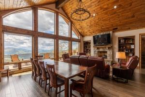 a dining room with a table and chairs and windows at Clouds Rest at Eagles Nest in Beech Mountain