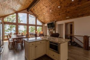an open kitchen and dining room with a table and chairs at Clouds Rest at Eagles Nest in Beech Mountain
