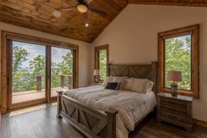 a bedroom with a bed and a large window at Clouds Rest at Eagles Nest in Beech Mountain