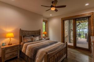 a bedroom with a bed and a ceiling fan at Clouds Rest at Eagles Nest in Beech Mountain