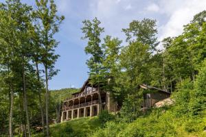 an old building on a hill in the woods at Clouds Rest at Eagles Nest in Beech Mountain