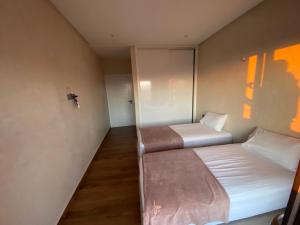 a room with two beds in a room with at Agadir well in Mirleft