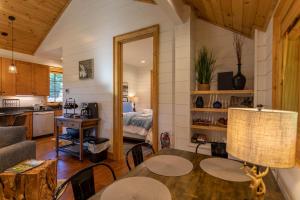 a kitchen and living room with a table and a bed at Banner Sky in Banner Elk