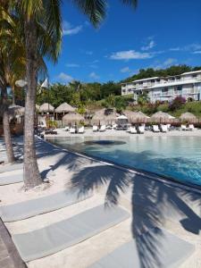 a view of the pool at the resort at Appart 'Caraibe Résidence MARINE HOTEL in Le Diamant