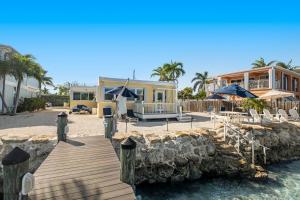a house on the beach with a wooden walkway at Casa Del Mar in Key Colony Beach
