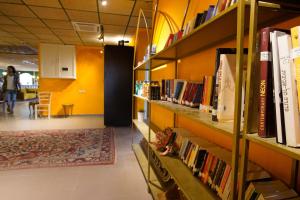 a library with several shelves filled with books at Selina Mantur Almog Dead Sea in Almog