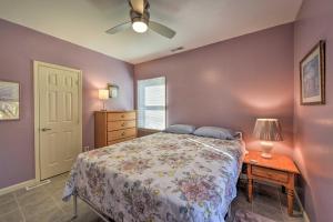 a bedroom with a bed and a table with a lamp at Serene West Cape May Getaway Walk to Beach! in Cape May