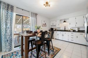 a kitchen and dining room with a table and chairs at The Torino in Bentonville