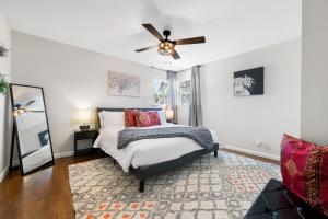 a bedroom with a bed and a ceiling fan at The Torino in Bentonville