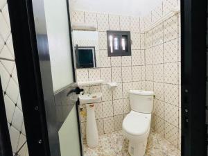 Baño pequeño con aseo y lavamanos en Charmante maison cozy et conviviale en Bafoussam