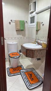 a bathroom with a toilet and a sink and a tub at 2 bedrooms new brand with amazing view in Ajman 