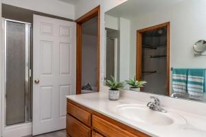 a bathroom with a sink and a mirror at The Betty in Bentonville +20 photos