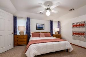 a bedroom with a bed and a ceiling fan at The Betty in Bentonville