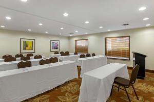 a conference room with white tables and chairs and a podium at Best Western PLUS Executive Hotel Richmond in Richmond