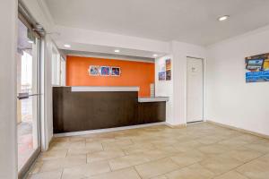 a hallway with an orange and white wall at Motel 6-Clovis, NM in Clovis