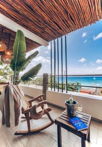 a room with a view of the ocean and a table at Albatros Suites by Bedsfriends in Cozumel