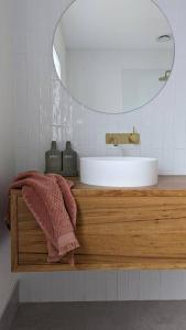 a bathroom with a sink and a mirror at Location & luxury 2BR 2 Bath in Albury