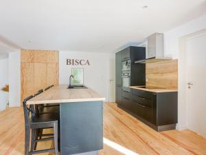 a kitchen with a wooden counter top in a room at Maison 3 étoiles, piscine chauffée, accès plage privée, 12 couchages, proche lac et forêt - FR-1-521-185 in Biscarrosse +9 photos