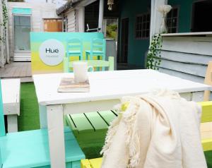 a table with a coffee cup on top of it at Hué Hostel in Punta Del Diablo