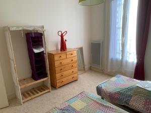 a bedroom with a dresser and a bed and a dresser with a dress at Appartement Mont-Dore, 2 pièces, 4 personnes - FR-1-415-129 in Le Mont-Dore