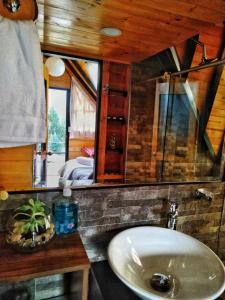 a bathroom with a sink and a mirror at Glamping refugio Gaia in Paipa
