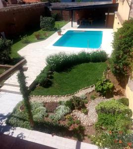 a garden with a swimming pool in a yard at Don Trujo 2 - parque y pileta in Mendoza