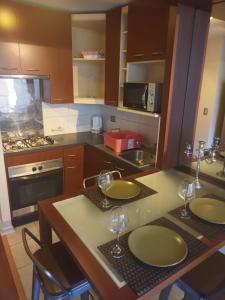 a kitchen with two empty wine glasses on a counter at Acogedor y renovado Departamento in Santiago