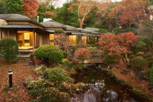 una casa con un laghetto di fronte a un giardino di 熱海慧薗貸し切り ad Atami