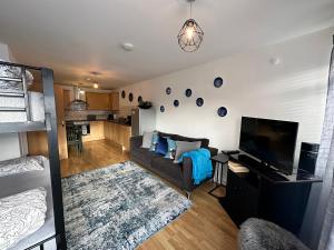 a living room with a couch and a flat screen tv at 1 stop to London Bridge in London