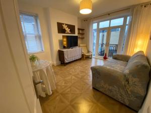 a living room with a couch and a table at Spacious 1 bedroom flat in London in London