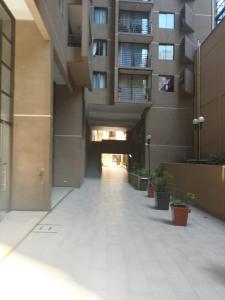 an empty hallway of a building with a building at Acogedor y renovado Departamento in Santiago +11 photos