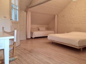 een slaapkamer met 2 bedden in een kamer met houten vloeren bij Gîte Berfay, 5 pièces, 11 personnes - FR-1-410-157 in Berfay