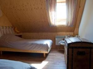 a small bedroom with a bed and a window at Maison en bois avec jardin, idéal randonnée, fibre haut débit, équipements bébé près du Mans et Tours - FR-1-410-195 in Thoiré-sur-Dinan