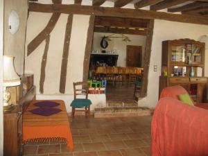 a living room with a table and chairs at Maison Spacieuse et Indépendante avec Jardin et Terrasse, Idéale pour Observer la Nature en Sarthe - FR-1-410-215 in Rouperroux-le-Coquet