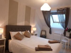 ein Schlafzimmer mit einem Bett mit zwei Handtüchern darauf in der Unterkunft Fermette rénovée avec terrasse, internet et garage près de Vallon-sur-Gée - FR-1-410-212 in Vallon-sur-Gée