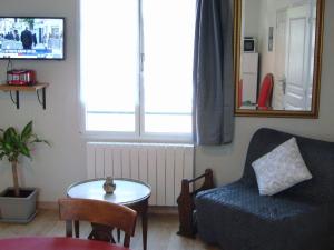 a living room with a couch and a table and a window at Gîte Montreuil-le-Henri, 2 pièces, 2 personnes - FR-1-410-225 in Montreuil-le-Henri