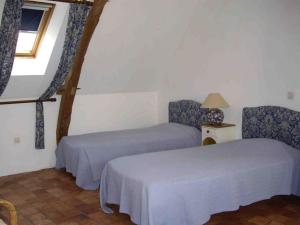 um quarto com duas camas e uma janela em Gîte Fontenay-sur-Vègre, 3 pièces, 4 personnes - FR-1-410-275 em Fontenay-sur-Vègre