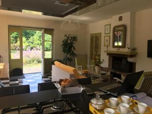 a living room with a table with a laptop on it at Gîte Montmirail, 5 pièces, 8 personnes - FR-1-410-266 in Montmirail