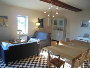 a living room with a blue couch and a table at Gîte Neufchâtel-en-Saosnois, 3 pièces, 6 personnes - FR-1-410-299 in Neufchâtel-en-Saosnois