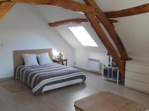 a bedroom with a bed in a attic at Gîte Neufchâtel-en-Saosnois, 3 pièces, 6 personnes - FR-1-410-299 in Neufchâtel-en-Saosnois